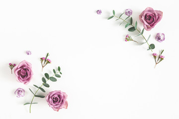Flowers composition. Frame made of eucalyptus branches and rose flowers on white background. Flat...