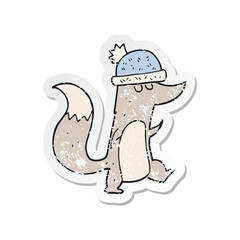 retro distressed sticker of a cartoon little wolf wearing hat