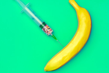 Minimal creative syringe with color drugs ( vitamins, dyes, antibiotics,  nutritional supplements, , artificial substitutes) on colored pastel background. Flat lay concept, copy space.