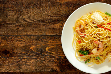 spicy spaghetti with seafood on plate.