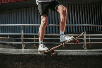 Fototapeta na wymiar Close up of an active man using his skateboard