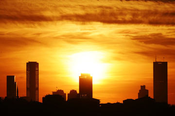 Silhouettes of skyscrapers of Istanbul against the sunset sky.