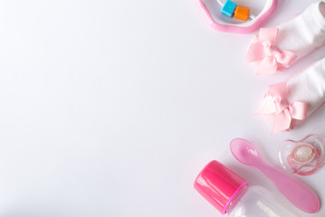 Baby care accessories and clothing on light background, top view