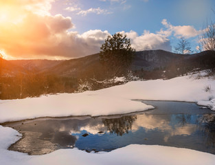 Fototapeta premium Spring first days in the mountains. Melting snow and beautiful views.