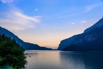 Beautiful colorful sunset on mountain lake Molveno in Italian Alps