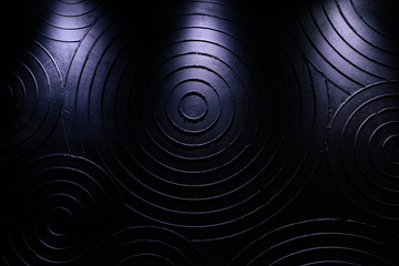 Black background composed of several concentric circles. Circles of various sizes in relief on a...