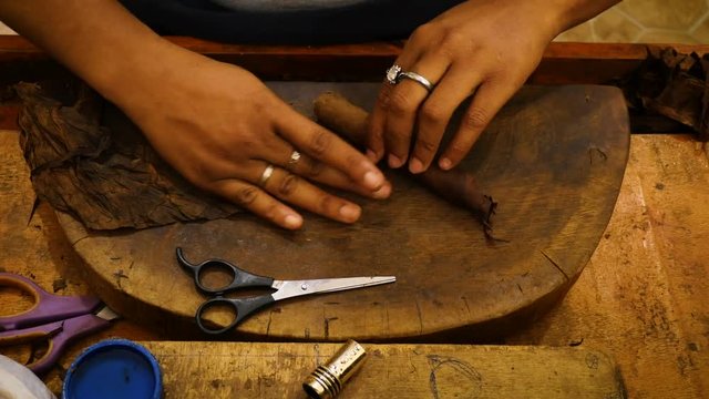 The process of a cigar being made by hand in a cigar factory in the Dominical republic.