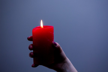 Red candle on blue background