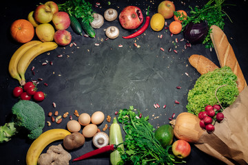 Healthy food background. Fresh vegetables and fruits on dark background. Top view with copy space