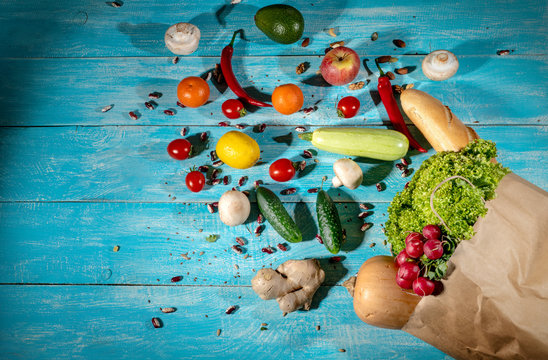 Healthy food background. Fresh vegetables and fruits on wooden background. Top view with copy space