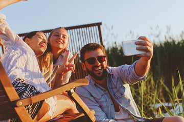 Young people taking selfie during the summer sunset