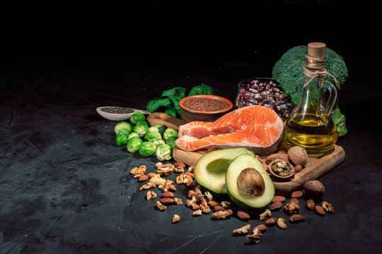 Food with natural vitamin Omega 3 and unsaturated fats. Concept of healthy vegan food on dark background