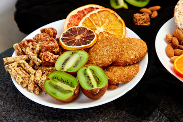 Healthy snacks -  variety oat granola bar,  rice crips, almond,  kiwi, dried orange