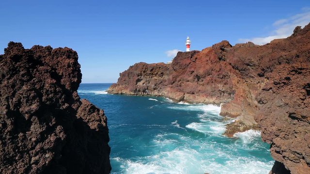 Panoramic view of the famous lighthouse of Teno and volcanic cliffs in the Isle of Tenerife in slow motion