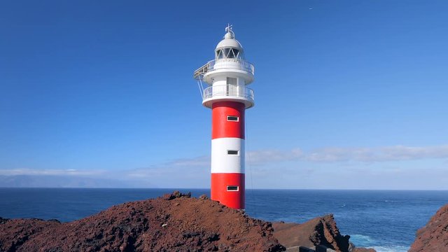 View of the famous lighthouse of Teno in the Isle of Tenerife. La Gomera island is in the background. HD cropped edit