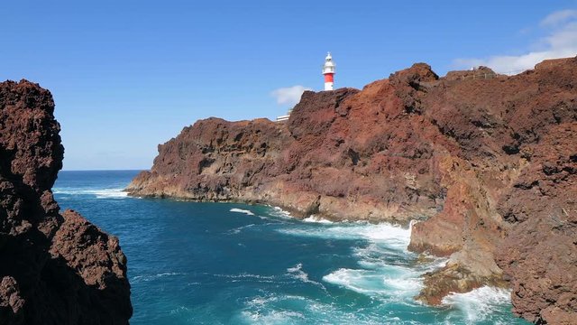 Panoramic view of the famous lighthouse of Teno and volcanic cliffs in the Isle of Tenerife in slow motion. HD cropped edit