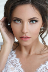 Beauty portrait of a beautiful girl with elegant wedding makeup.
