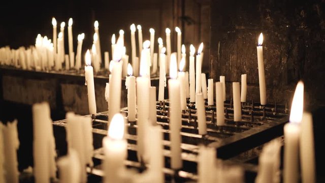 Burning candles in a church, Purgatory and prayer candles, 4k footage