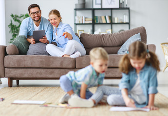 happy family mother father and kids draw together at home  .