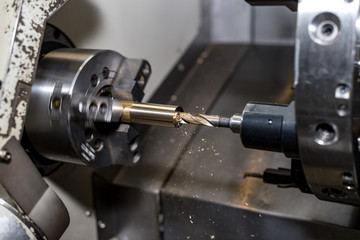 Fototapeta na wymiar metal blank machining process on lathe with cutting tool