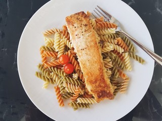 A plate with salmon and pasta