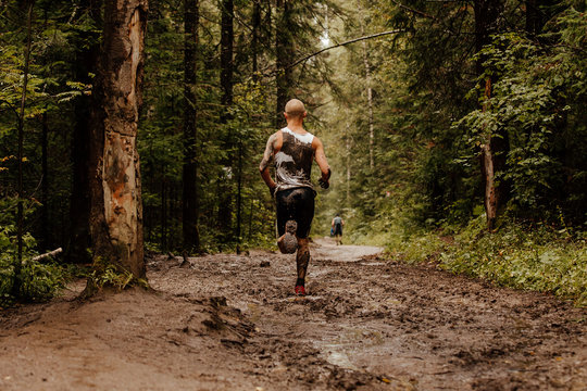 Back Bald Male Runner Run On Dirt Trail In Forest