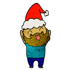 man with beard sticking out tongue wearing santa hat
