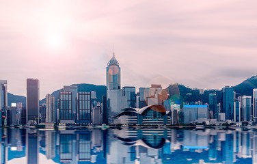 Hong Kong cityscape in the morning : View from Victoria Harbour with beautiful sunrise and reflection