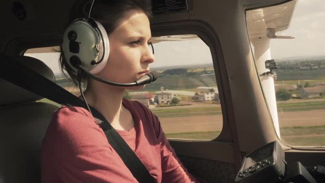 Small private plane approach to landing in a farmland area cabin view