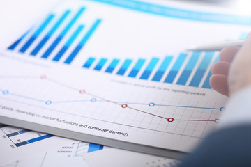 Male hands hold documents laptop with financial