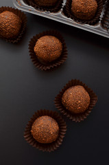 chocolate petit fours over black background. Top view.