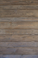 Wooden boards are located horizontally. Cracked, wood knots