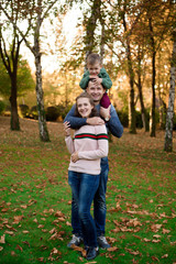 Happy family resting in beautiful autumn park