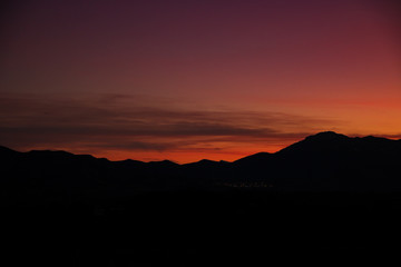 sunset sky in dark mountain silhouette 