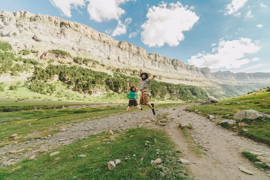 Young couple jumping in a big valley of soaso