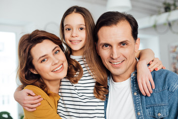 Obraz premium Happy family posing on camera together at home