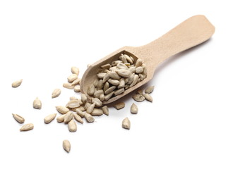 Sunflower seeds with wooden spoon isolated on white background