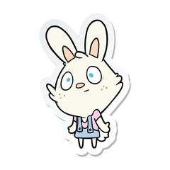 Obraz na płótnie Canvas sticker of a cartoon rabbit shrugging shoulders