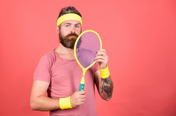 Athlete hipster hold tennis racket in hand red background. Play tennis for fun. Man bearded hipster wear sport outfit. Reach top again. Tennis player retro fashion. Tennis sport and entertainment
