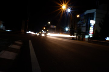 Artistic style dark defocused and blured lights of night in the city