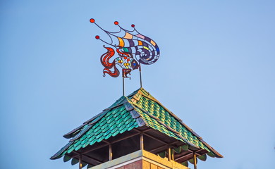 Turret with  tiled roof and  bright weather vane
