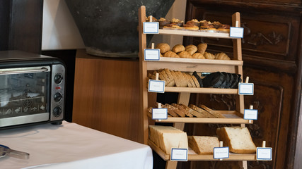 A lot of bread is placed beside the oven.