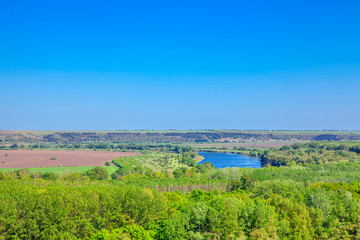 Fototapeta na wymiar Aerial view of tranquil winding river , amid lush green landscape 