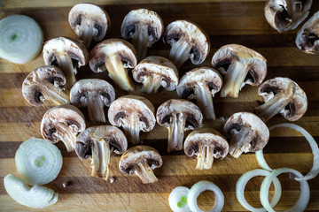 Champignon mushrooms on kitchen desk prepared to cook vegetarian healthy food. Vegan natural food concept