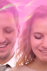 Studio close up portrait of two halves of a positive smiling man and woman with closed eyes on pink background.