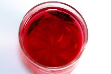 Bright red jelly in a glass on a light and dark background
