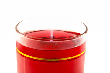 Bright red jelly in a glass on a light and dark background