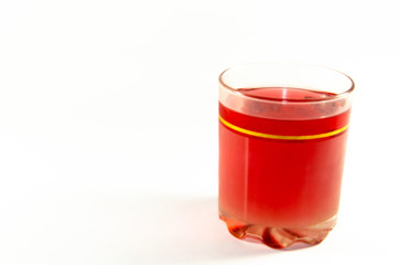 Bright red jelly in a glass on a light and dark background