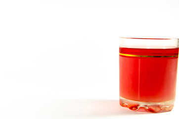 Bright red jelly in a glass on a light and dark background