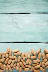 Fototapeta na wymiar peanuts on wooden surface